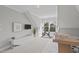 Bright bonus room with vaulted ceiling, carpet, Peloton exercise bike, and home office at 109 Yorkchester Way, Raleigh, NC 27615