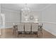 Formal dining room with elegant chandelier, setting for eight, and wood floors at 109 Yorkchester Way, Raleigh, NC 27615