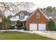 Attractive brick home with a two-car garage, snow-covered roof and well-kept front lawn at 109 Yorkchester Way, Raleigh, NC 27615