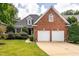 Charming brick home with a well-manicured lawn and a two-car garage at 109 Yorkchester Way, Raleigh, NC 27615