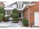 Charming brick home with well-maintained landscaping and snow-covered ground at 109 Yorkchester Way, Raleigh, NC 27615