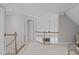 Hallway with white railings and a view into a bonus room with sloped ceilings at 109 Yorkchester Way, Raleigh, NC 27615