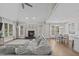 Open-concept living room featuring a fireplace, hardwood floors, and plush sectional at 109 Yorkchester Way, Raleigh, NC 27615