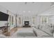 Bright living room featuring a fireplace, hardwood floors, and plush sectional at 109 Yorkchester Way, Raleigh, NC 27615