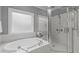 Bright bathroom featuring a soaking tub and a separate glass shower at 1104 Hobson Ct, Raleigh, NC 27607