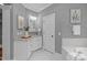 Bathroom with vanity, granite countertops, soaking tub and glass-enclosed shower at 1104 Hobson Ct, Raleigh, NC 27607