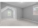 Bedroom with neutral carpet, grey walls, and two large windows at 1104 Hobson Ct, Raleigh, NC 27607
