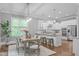 Open dining area and kitchen with stylish lighting and a large window with natural light at 1104 Hobson Ct, Raleigh, NC 27607