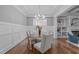 Bright dining room with tray ceilings, wainscoting, and hardwood floors at 1104 Hobson Ct, Raleigh, NC 27607