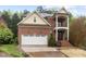 Two-story brick home with a two-car garage and a covered front porch at 1104 Hobson Ct, Raleigh, NC 27607