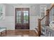 Inviting foyer with hardwood floors, paneled walls, and double doors at 1104 Hobson Ct, Raleigh, NC 27607