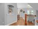 Hallway featuring hardwood floors, decorative niche, and views into the living space at 1104 Hobson Ct, Raleigh, NC 27607