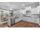 Spacious kitchen with stainless steel appliances, a large sink, and an adjacent dining area at 1104 Hobson Ct, Raleigh, NC 27607