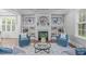 Cozy living room featuring a fireplace, built-in shelves, and stylish decor at 1104 Hobson Ct, Raleigh, NC 27607