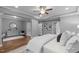 Comfortable main bedroom featuring tray ceilings, a ceiling fan, and hardwood floors at 1104 Hobson Ct, Raleigh, NC 27607