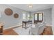 Bright home office with a wooden desk, hardwood floors, and natural light from the glass panel double doors at 1104 Hobson Ct, Raleigh, NC 27607