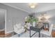 Office area with a wooden desk, hardwood floors, and seating area with gray walls at 1104 Hobson Ct, Raleigh, NC 27607
