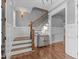 Elegant staircase with hardwood steps, white wainscoting and iron balusters at 1104 Hobson Ct, Raleigh, NC 27607