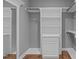 Well-designed walk-in closet with custom shelving, drawers and hardwood floor at 1104 Hobson Ct, Raleigh, NC 27607
