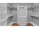 Organized walk-in closet with custom shelving, drawers and hardwood floor at 1104 Hobson Ct, Raleigh, NC 27607