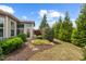 Landscaped backyard features lush landscaping, trees, stone pathway, and a charming patio area for relaxing at 1108 Cadence Ln, Durham, NC 27703