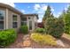 Backyard features lush landscaping, trees, stone pathway, and a charming patio area for relaxing at 1108 Cadence Ln, Durham, NC 27703