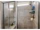 Modern shower with gray tile surround, glass door, built-in niche, and rainfall shower head at 1108 Cadence Ln, Durham, NC 27703