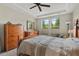 Inviting bedroom features a wooden dresser, a large bed, and serene natural light through the picturesque windows at 1108 Cadence Ln, Durham, NC 27703