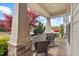 Inviting front porch with rocking chairs, stone accents, and a view of the landscaped yard at 1108 Cadence Ln, Durham, NC 27703