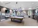 Bright game room featuring two pool tables, seating and large windows for natural light at 1108 Cadence Ln, Durham, NC 27703