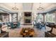 Elegant living room showcasing a stone fireplace, custom bookshelves and stylish furniture at 1108 Cadence Ln, Durham, NC 27703