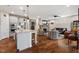 Open floor plan with gourmet kitchen flows into the living room and stone fireplace at 1108 Cadence Ln, Durham, NC 27703