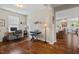 Home office with hardwood flooring, a dedicated workspace, and an open layout to other living areas at 1108 Cadence Ln, Durham, NC 27703