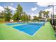 Bright pickleball courts on a sunny day, surrounded by trees and greenery for a community activity at 1108 Cadence Ln, Durham, NC 27703