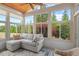 Relaxing sunroom with floor-to-ceiling windows, a comfortable sofa, and tranquil views of the surrounding greenery at 1108 Cadence Ln, Durham, NC 27703
