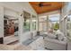 Bright sunroom with many windows, comfortable seating, and a ceiling fan for maximum relaxation at 1108 Cadence Ln, Durham, NC 27703