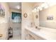 Classic bathroom featuring white tiled walls, a vanity with ample lighting, and a shower-tub combo at 1108 Friendly Rd, Dunn, NC 28334