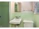 Vintage bathroom featuring light green tile, a sink, and a walk-in shower at 1108 Friendly Rd, Dunn, NC 28334