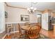 Dining room area with wooden table, decorative rug, and elegant light fixture at 1108 Friendly Rd, Dunn, NC 28334
