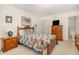 Comfortable bedroom with a colorful quilt, wood furniture, and closet space at 1108 Friendly Rd, Dunn, NC 28334
