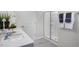 Modern bathroom featuring double sinks, quartz countertop, and a glass-enclosed shower at 1109 Ursa Major Ct, Wendell, NC 27591