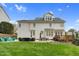 Expansive backyard with lush lawn, patio area, and grill; perfect for outdoor entertaining, and a white home at 1113 Colonial Club Road Rd, Wake Forest, NC 27587