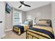 Shared bedroom with two twin beds, ceiling fan, and natural light at 1113 Colonial Club Road Rd, Wake Forest, NC 27587