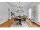 Elegant dining room features hardwood floors, a decorative chandelier, and neutral-toned seating at 1113 Colonial Club Road Rd, Wake Forest, NC 27587