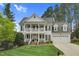 Inviting two-story traditional-style home boasting a charming double porch and well-manicured front lawn at 1113 Colonial Club Road Rd, Wake Forest, NC 27587