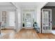 Bright and airy foyer with hardwood floors, a decorative bench, and views into adjacent living spaces at 1113 Colonial Club Road Rd, Wake Forest, NC 27587