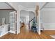 Inviting foyer showcasing hardwood floors and an arched doorway leading to a bright living area at 1113 Colonial Club Road Rd, Wake Forest, NC 27587