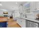 Modern kitchen featuring stainless appliances, ample counter space, and view to the dining and living areas at 1113 Colonial Club Road Rd, Wake Forest, NC 27587