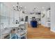 Bright, open kitchen with white cabinets, a blue island, stainless steel appliances, and a breakfast nook at 1113 Colonial Club Road Rd, Wake Forest, NC 27587