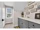 Bright laundry room with gray cabinetry, marble countertops and wood flooring at 1113 Colonial Club Road Rd, Wake Forest, NC 27587